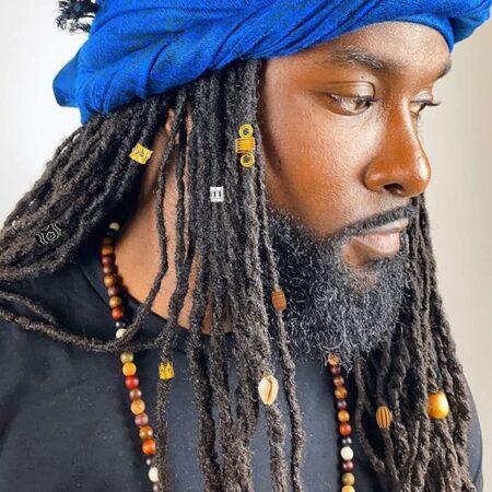 5 best dreadlock beads and cuffs to style your locs in 2026 long dreadlocks with gold cuffs, wooden beads and a cowrie shell — featured image for dreadlock beads and cuffs roundup