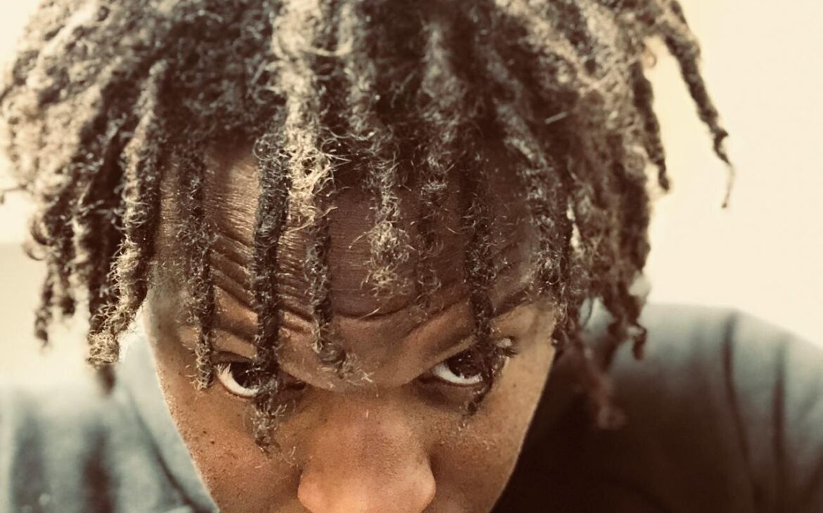 best rosemary oil for dreadlocks arranged on wooden surface with locs background